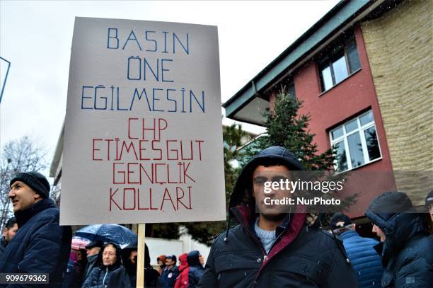 Man holding a placard poses for a photo as people gather on the spot, where Turkish journalist Ugur Mumcu was assassinated, during a commemoration to...