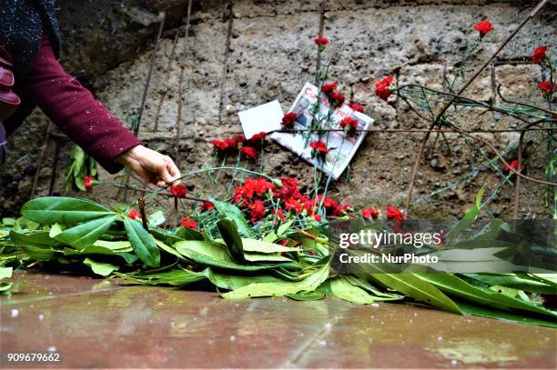 Woman lays a flower as people gather on the spot, where Turkish journalist Ugur Mumcu was assassinated, during a commemoration to mark the 25th...