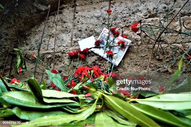 Flowers are placed next to the wall of a monument as people gather on the spot, where Turkish journalist Ugur Mumcu was assassinated, during a...