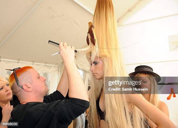 Designer Charlie Le Mindu prepares a model backstage ahead of the Charlie Le Mindu Spring/Summer 2010 show as part of Blow Presents during London...