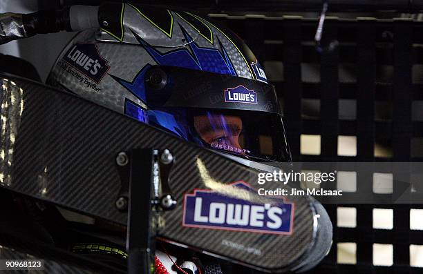 Jimmie Johnson, driver of the Lowe's Chevrolet, sits in his car during practice for the NASCAR Sprint Cup Series Sylvania 300 at the New Hampshire...