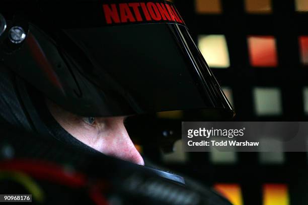 Dale Earnhardt Jr., driver of the AMP Energy/National Guard Chevrolet, sits in his car during practice for the NASCAR Sprint Cup Series Sylvania 300...