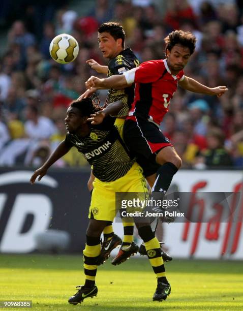 Tinga and Nuri Sahin of Dortmund and Chahed Sofian of Hannover battle for the ball during the Bundesliga match between Hannover 96 and Borussia...