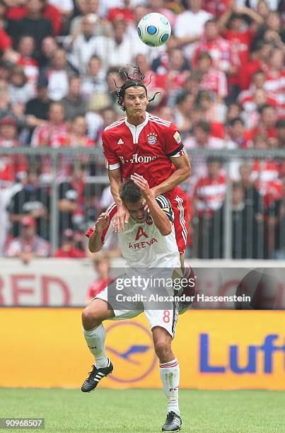 Daniel van Buyten of Muenchen battles for the ball with Christian Eigler of Nuernberg during the Bundesliga match between FC Bayern Muenchen and 1....