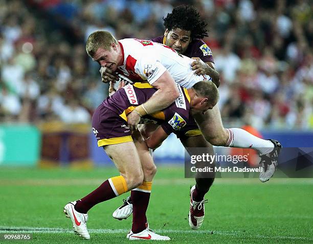 Darren Lockyer and Sam Thaiday of the Broncos tackle Ben Creagh of the Dragons during the second NRL semi final match between the Brisbane Broncos...