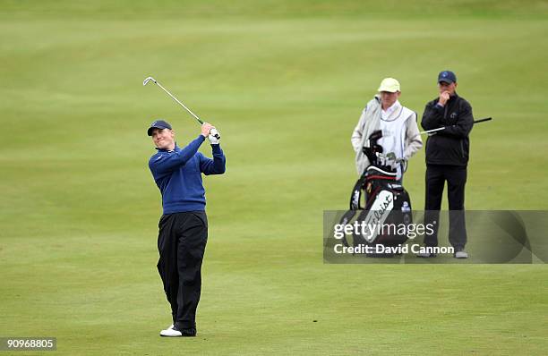 Will Barnes of England plays his second shot, watched by his partner Jon Bevan of England and the Great Britain and Ireland Team at the 10th hole...