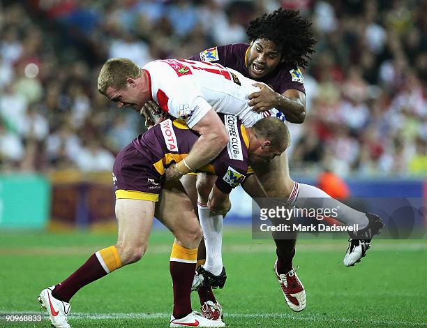 Darren Lockyer and Sam Thaiday of the Broncos tackle Ben Creagh of the Dragons during the second NRL semi final match between the Brisbane Broncos...