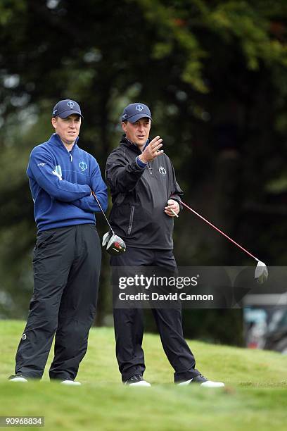 Will Barnes of England and his partner Jon Bevan of England and the Great Britain and Ireland Team talk at the 11th hole during the morning foursome...