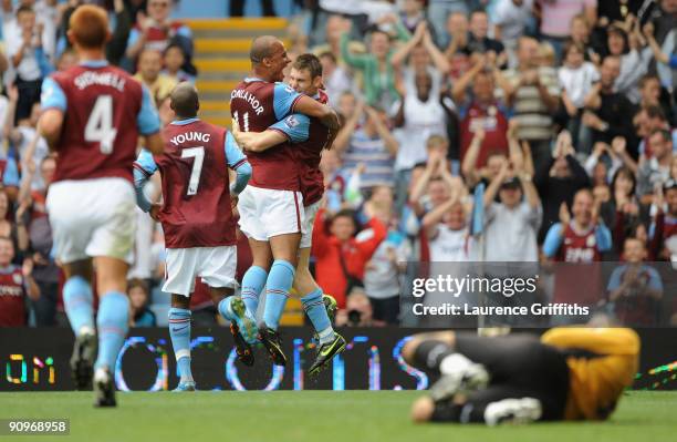 James Milner of Aston Villa is congratulated by Gabriel Agbonlahor after scoring from the spot during the Barclays Premier League match between Aston...