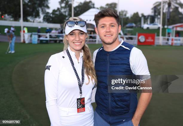 Niall Horan the music artist with Paige Spiranac of the United States during the pro-am as a preview for the Omega Dubai Desert Classic on the Majlis...