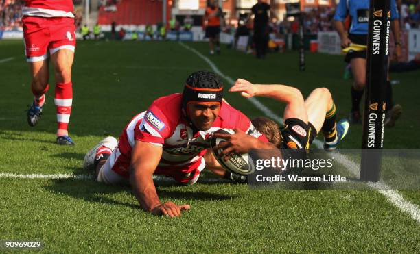 Akapusi Qera of Gloucester dives over to score a try during the Guinness Premiership match between Gloucester Rugby and Northampton Saints on...