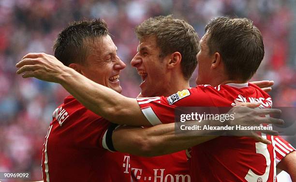 Ivica Olic of Muenchen celebrates scoring his first team goal with his team mates Thomas Mueller and Bastian Schweinsteiger during the Bundesliga...