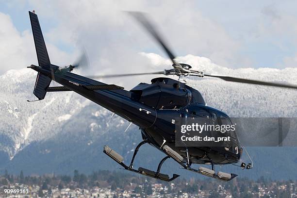 helicopter in flight - heli skiing stock pictures, royalty-free photos & images
