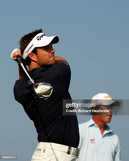 Benn Barham of England tees off at the 15th watched by Richard Green of Australia during the third round of the Austrian Golf Open at Fontana Golf...