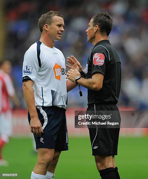 Kevin Davies of Bolton argues with referee Mark Clattenburg during the Barclays Premier League match between Bolton Wanderers and Stoke City at the...