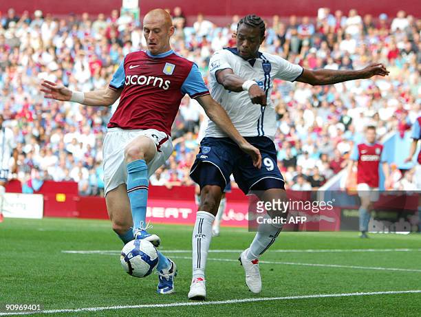 Aston Villa's Welsh player James Collins vies with Portsmouth French striker Fredric Piquionne during the English Premier League football match...