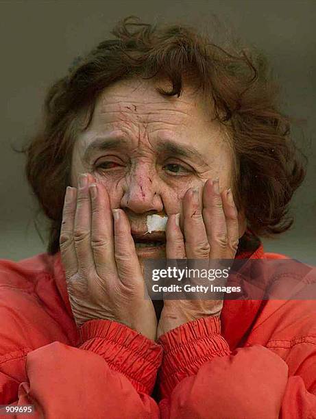 An unknown injured Serb woman cries in front of her destroyed home in the town of Aleksinac, some 200 kilometers south of Belgrade, Yugoslavia, early...