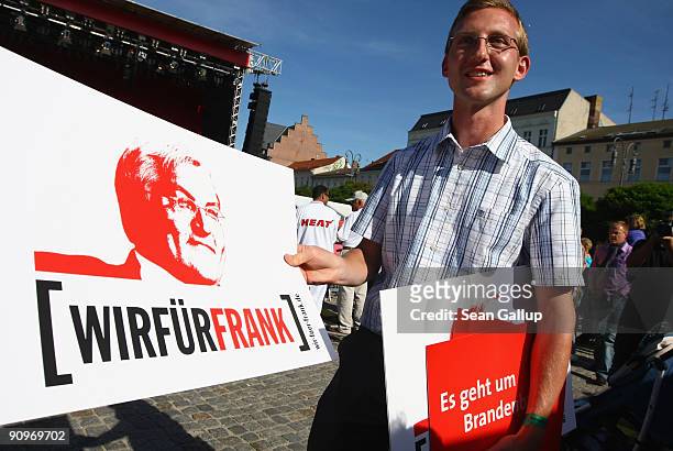 Supporter of German Vice Chancellor, Foreign Minister and lead candidate for the German Social Democrats Frank-Walter Steinmeier distributes signs...