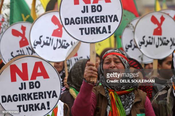 Syrian-Kurds march during a demonstration in the northeastern Syrian city of Qamishli on January 24 against the Turkish assault on the border enclave...