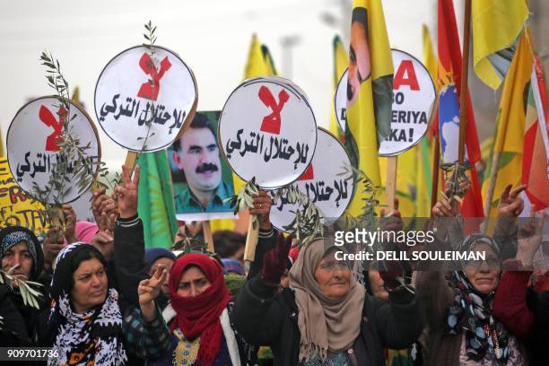 Syrian-Kurds march during a demonstration in the northeastern Syrian city of Qamishli on January 24 against the Turkish assault on the border enclave...
