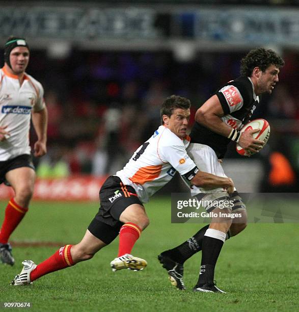 Ryan Kankowski of the Sharks is tackled by Louis Strydom of Cheetahs during the Absa Currie Cup match between the Sharks and Free State Cheetahs at...