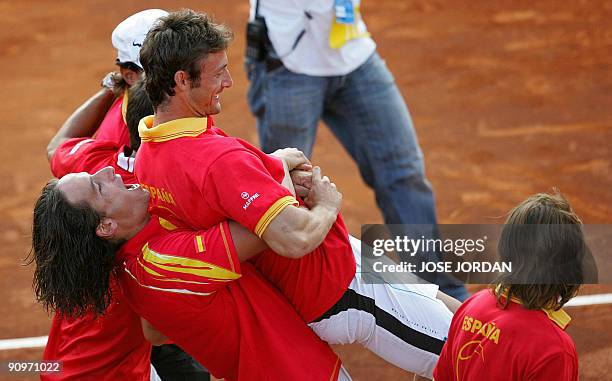 Spain's Feliciano Lopez and Juan Carlos Ferrero celebrate after winning the third match of the Davis cup semifinal between Spain and Israel at the...