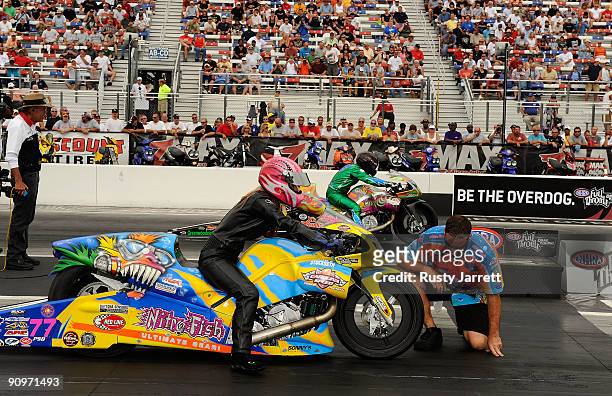 Angie McBride, rider of the Nitro Fish/MSR/Red Line Oil Buel is staged by a crew member during the NHRA Carolinas Nationals on September 19, 2009 at...