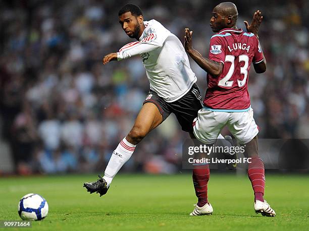 Ryan Babel of Liverpool runs round Herita Ilunga of West Ham during the Barclays Premier League match between West Ham and Liverpool at Upton Park on...