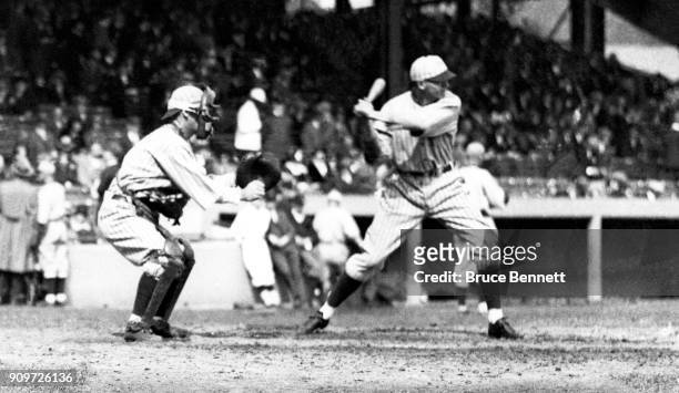 Fred Lindstrom of the New York Giants bats as catcher Muddy Ruel of the Washington Senators sets up behind home plate during a game in the 1924 World...
