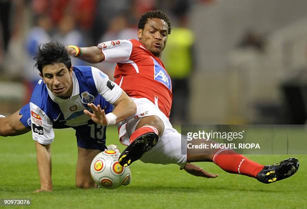 Porto's Jorge Fucile vies with SC Braga's Albert Meyong during their Portuguese First league football match at the AXA Stadium in Braga, on September...