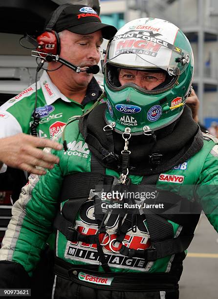 John Force, driver of the Castrol GTX High Mileage Ford prepares to drive during qualifying for the NHRA Carolinas Nationals on September 19, 2009 at...