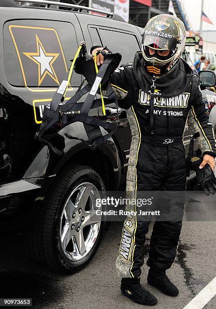 Tony Schmacher, driver of the US Army top fuel dragster prepares to drive during qualifying for the NHRA Carolinas Nationals on September 19, 2009 at...