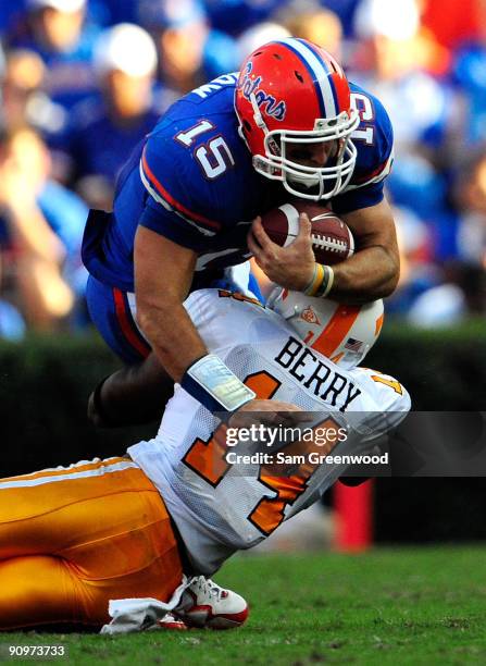 Tim Tebow of the Florida Gators is tackled by Eric Berry of the Tennessee Volunteers during the game at Ben Hill Griffin Stadium on September 19,...