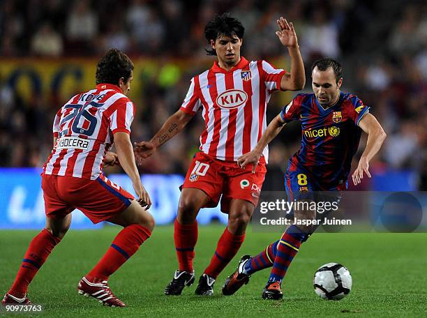 Andres Iniesta of Barcelona duels for the ball with Sergio Aguero and Koke of Atletico Madrid during the La Liga match between Barcelona and Atletico...