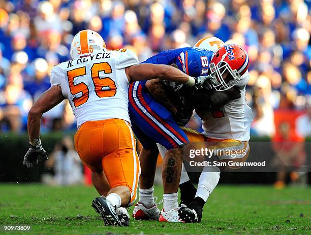 Aaron Hernandez of the Florida Gators is tackled by Nick Reveiz of the Tennessee Volunteers during the game at Ben Hill Griffin Stadium on September...