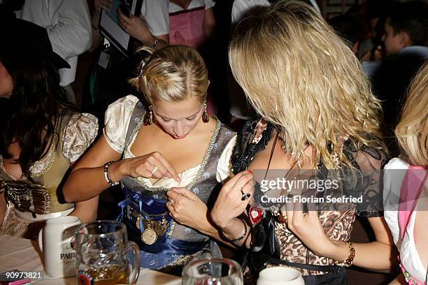 Verena Kerth and guest compare outfits during the Oktoberfest 2009 opening at Kaefer Schaenke at the Theresienwiese on September 19, 2009 in Munich,...