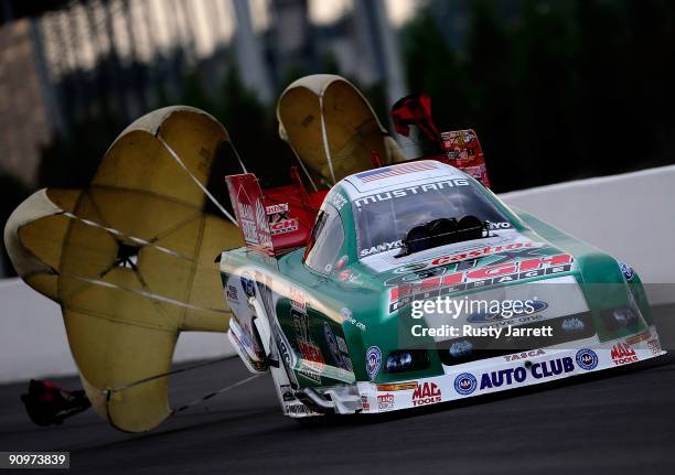 John Force, driver of the Castrol GTX High Mileage Ford funny car drives during qualifying for the NHRA Carolinas Nationals on September 19, 2009 at...