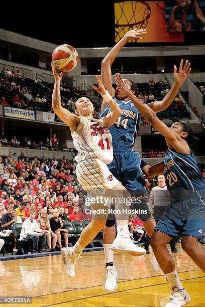 Tully Bevilaqua of the Indiana Fever battles Chasity Melvin and Alana Beard of the Washington Mystics during Game Two of the Eastern Conference...