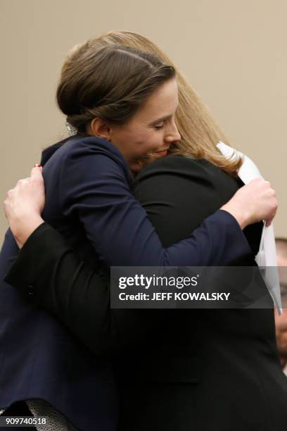 Michigan Assistant Attorney General Angela Povilaitis and Rachael Denhollander embrace as former Michigan State University and USA Gymnastics doctor...