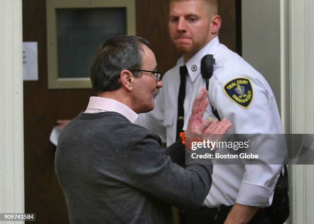 John Feroli waves to his family as he leaves the courtroom during a bail hearing in Brockton Superior Court in Brockton, MA before a new trial set...