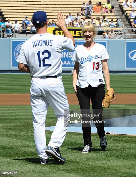 Dodgers catcher Brad Ausmus greets actress Jenna Elfman after the ceremonial first pitch at Dodger Stadium on September 19, 2009 in Los Angeles,...