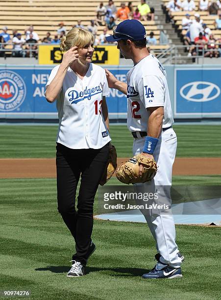 Dodgers catcher Brad Ausmus greets actress Jenna Elfman after the ceremonial first pitch at Dodger Stadium on September 19, 2009 in Los Angeles,...