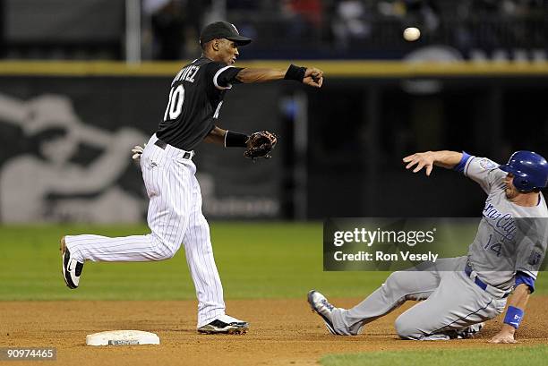 Alexei Ramirez of the Chicago White Sox turns a double play over a sliding John Buck of the Kansas City Royals on September 19, 2009 at U.S. Cellular...