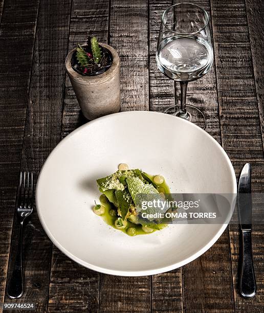 Sponge cake with avocado oil, macadamia nuts, cold tomato soup, broken pineapple cream, avocado sorbet and matcha tea tiles cooked in oven, is served...