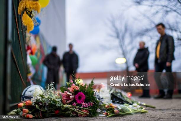 Flowers and a football are left at a makeshift memorial placed in front of the Kaethe Kollwitz comprehensive school as people mourn following the...