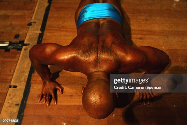 Former All Black international rugby player Jonah Lomu performs push ups backstage prior to his competitive debut in the over-90kg novice category at...