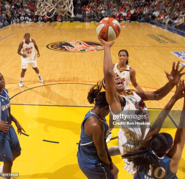 Tamika Catchings of the Indiana Fever battles Lindsey Harding of the Washington Mystics during Game 2 of the Eastern Conference Semifinals at Conseco...