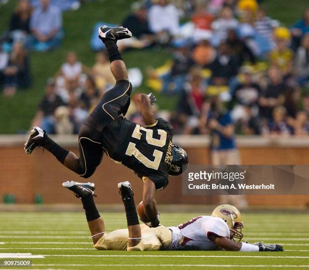 Running back Josh Adams of the Wake Forest Demon Deacons is upended by defensive back Karlos Sullivan of the Elon Phoenix during first half action at...
