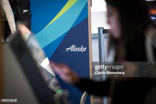 Traveler uses an Alaska Air Group Inc. Self check-in kiosk at the San Francisco International Airport in San Francisco, California, U.S., on Friday,...