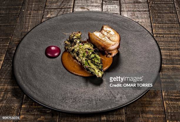 Dish called "Lechon Confitado" with "Xanducata" and purple carrot, is pictured at Mexican chef Fernando Martinez's restaurant "Seneri" -which...